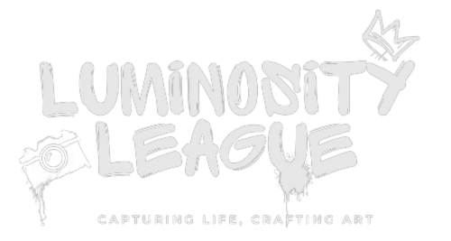 Luminosity League logo with bold, stylized black text, a camera icon on the left, and a crown on top of the letter 'Y.' Tagline below reads 'Capturing Life, Crafting Art.